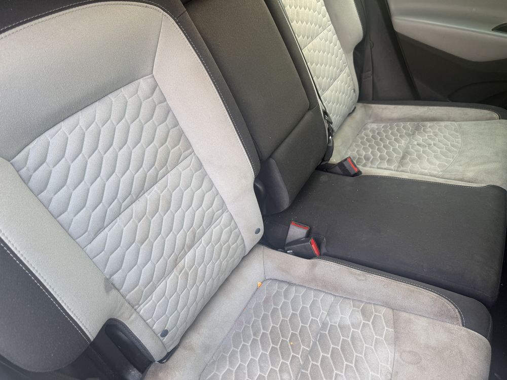 Rear seats before interior detailing, visibly dirty and worn
